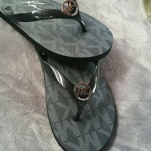 MK black flip flops